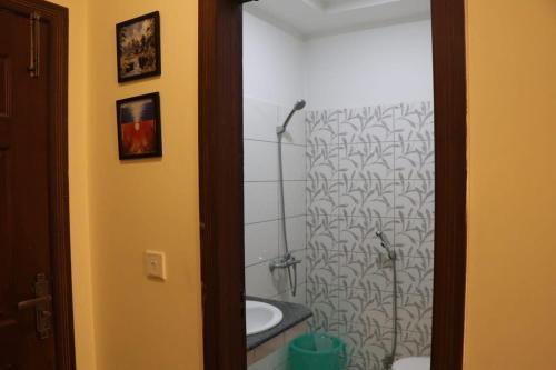 a bathroom with a shower curtain and a sink at Cozy Studio Apartment In Bahria town in Rawalpindi