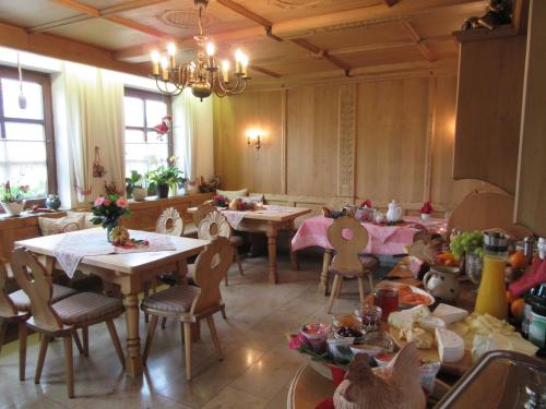 a restaurant with tables and chairs in a room at Pension Bauer in Ebern