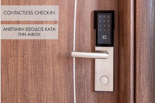 a door handle with a sign on a wooden door at BOUTiE Premium, a KalamataStay Property in Kalamata