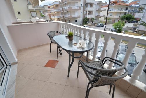 a balcony with a table and chairs on a balcony at Epavlis Luxury apts in Leptokaria
