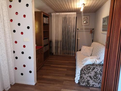 a living room with a couch and a wall with polka dots at Namiņš AMRAI in Ventspils