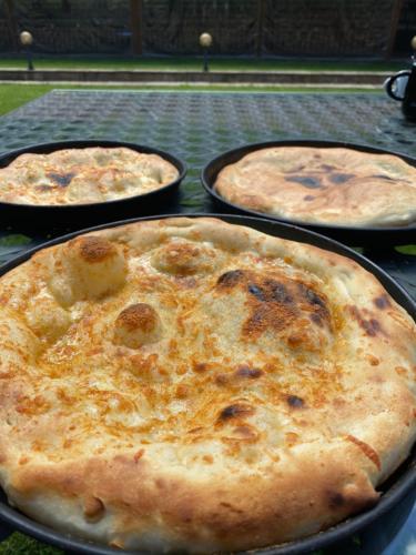 a group of pizzas sitting on top of a table at Hotel Bozhentsi in Chernevtsi