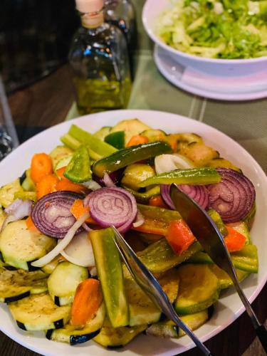 a plate of food with vegetables on a table at Hotel Bozhentsi in Chernevtsi
