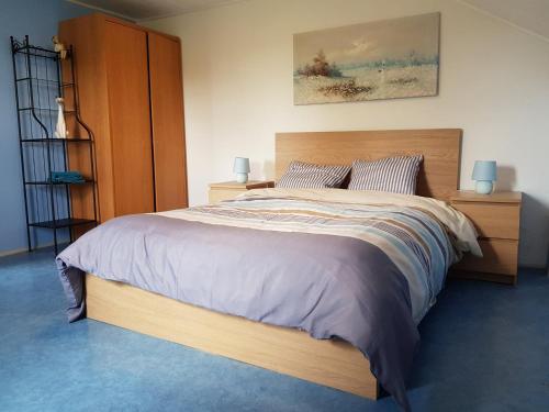 ein Schlafzimmer mit einem großen Bett mit zwei Lampen in der Unterkunft Les Glycines in Gouvy