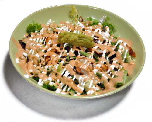 a plate of food with a salad in a bowl at Pensión San Marcos in Arcos de la Frontera