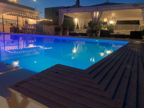 a swimming pool at night with lights in it at White House Luxury Hospitality in Olbia