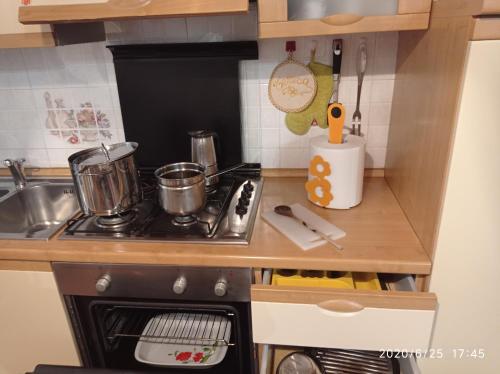a small kitchen with a stove and a sink at EMY & LU CASA VACANZE CITTA' ALTA Centro Storico in Bergamo