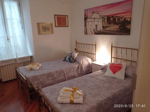 a bedroom with two beds with towels on them at EMY & LU CASA VACANZE CITTA' ALTA Centro Storico in Bergamo
