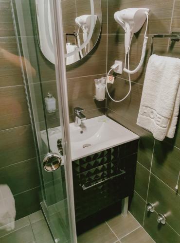 a bathroom with a sink and a shower at Vazdušna Banja in Niš