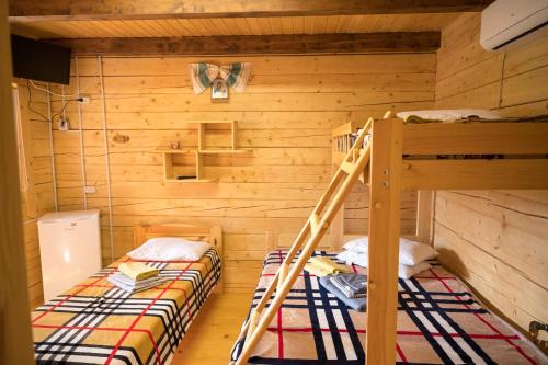 two bunk beds in a room with wooden walls at Rybatska 7 in Chornomorsk