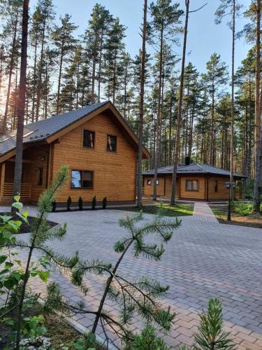 a log cabin with a driveway in front of it at Splife semi-detached cottage in Kuru