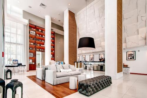 a living room with a couch and a table at Bluebird Suites Monte Carlo Miami Beach in Miami Beach