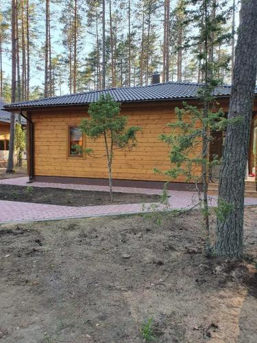 a log cabin with a tree in front of it at Splife semi-detached cottage in Kuru