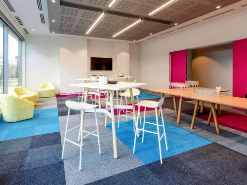 a meeting room with a table and chairs in a room at ibis Styles East Perth in Perth