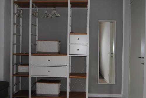 a closet with white drawers and a mirror at Villa Smeralda in San Vito lo Capo