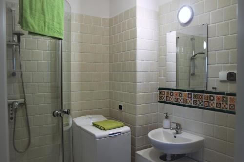 a bathroom with a sink and a toilet and a shower at Apartament Motyl in Władysławowo
