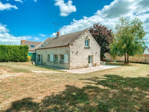 an old stone house with a yard at Cozy Farm House in Boncourt with Barbeque in Sainte-Preuve