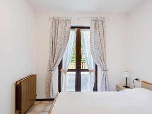 a bedroom with a bed and a window at Apartment in Ledro by Lake & Dolomites in Ledro