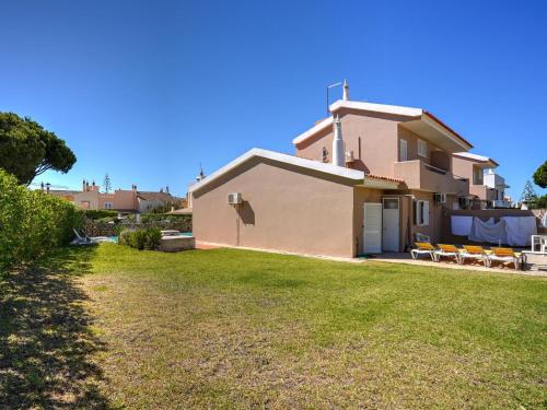 a house with a lawn in front of it at Beautiful Holiday Home in Vilamoura with Private Pool in Vilamoura
