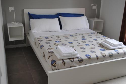 a bed with two towels and pillows on it at Villa Smeralda in San Vito lo Capo