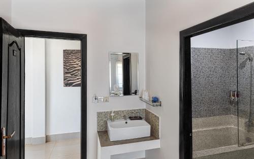 a bathroom with a sink and a shower at Villa Agati in Siem Reap