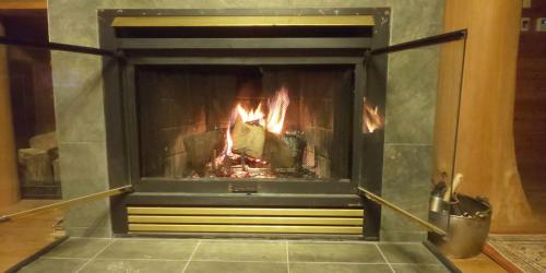 a fireplace with a fire in it at えころっじKitsuki in Kitsuki