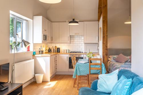 a kitchen and a living room with a table at Nutley Farm in Winfrith Newburgh