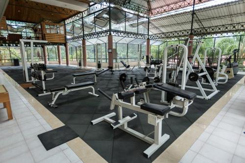 a gym with several treadmills and machines at Park Hotel in Santa Cruz Verapaz