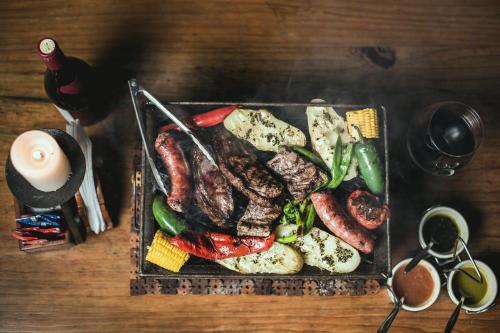 a plate of food with meat and vegetables on a table at Park Hotel in Santa Cruz Verapaz