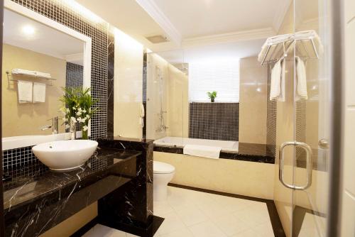 a bathroom with a sink and a toilet and a shower at Rex Hotel Vung Tau in Vung Tau