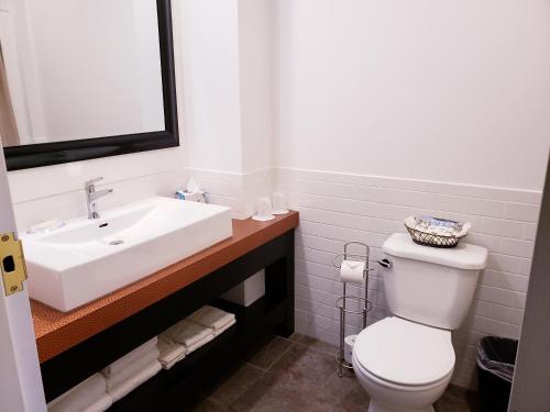 a bathroom with a white sink and a toilet at Lowell Inn in Stillwater
