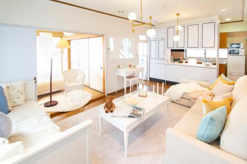 a living room with a couch and a table at HARMONIA東京堀切 10名定員90平米の広いCondominium in Tokyo