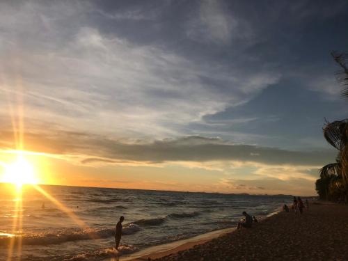 a group of people on the beach at sunset at Anise hotel in Phu Quoc