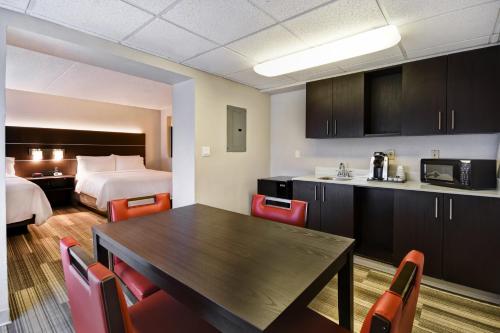 a hotel room with a table and a bed at Holiday Inn Express & Suites Allentown-Dorney Park Area by IHG in Allentown