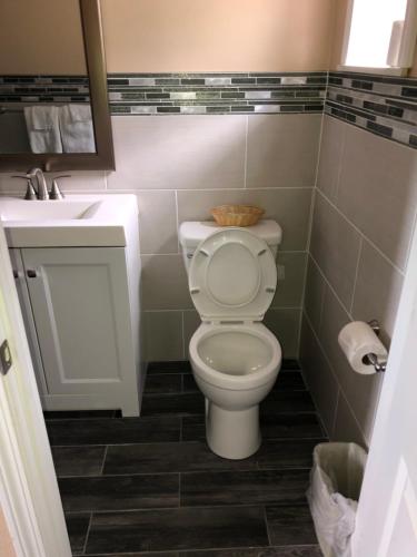 a bathroom with a toilet and a sink at Skyview Motor Inn in Johnston