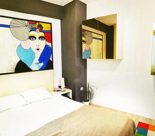 a bedroom with a bed and a painting on the wall at Aldor 2 Mamaia Nord in Mamaia Sat/Năvodari