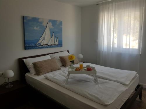 a bedroom with a large bed with a table on it at Vila Hrvatska in Ražanj
