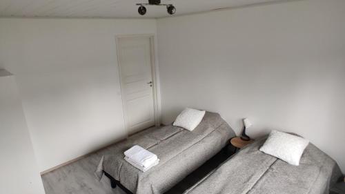 a living room with two beds and a stool at Apartments, 4 rooms + sauna in Kajaani