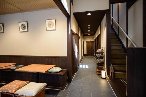 a hallway with two beds and a staircase at Luck You Kyoto in Kyoto