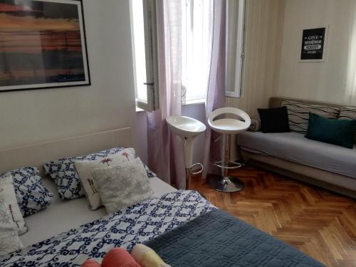 a living room with a couch and a table at Optimist split/city center in Split