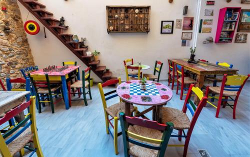 a room with tables and chairs and a staircase at Poco Loco Bed & Breakfast in Chania Town