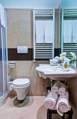 a bathroom with a sink and a toilet and a shower at Crosti Hotel in Rome