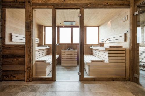 a large room with wooden walls and wooden stairs at Residence Panorama Pfelders in Pfelders