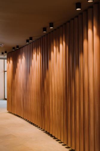 a row of wooden walls in a room at Ensana Ursina in Sovata