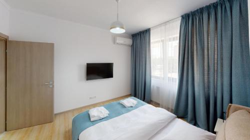 a hotel room with a bed and a window at Le Blanc ApartHotel in Bucharest