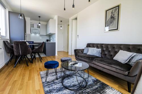 a living room with a couch and a table at Luce Gold Apartment in Zadar
