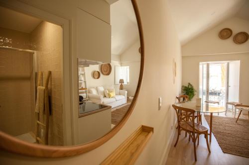 a large mirror in a living room with a table at Ana´s House in Setúbal