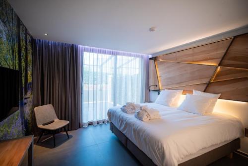 Een bed of bedden in een kamer bij L'Ardenne Autrement