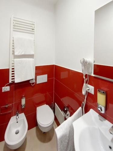 a bathroom with a white toilet and a sink at Roma Resort Colosseum in Rome
