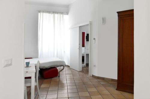 a bedroom with a bed and a desk and a table at Roma Resort Colosseum in Rome